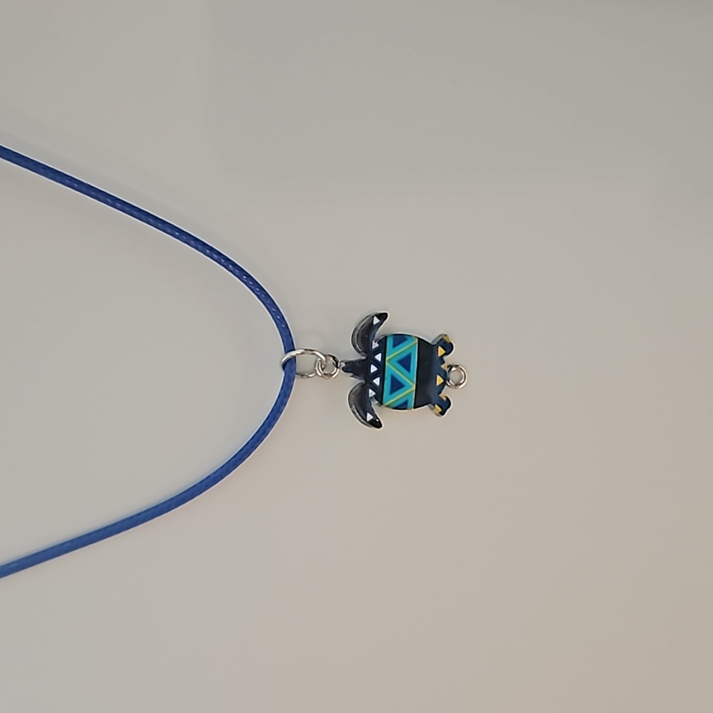 Turtle charm on corded leather necklace